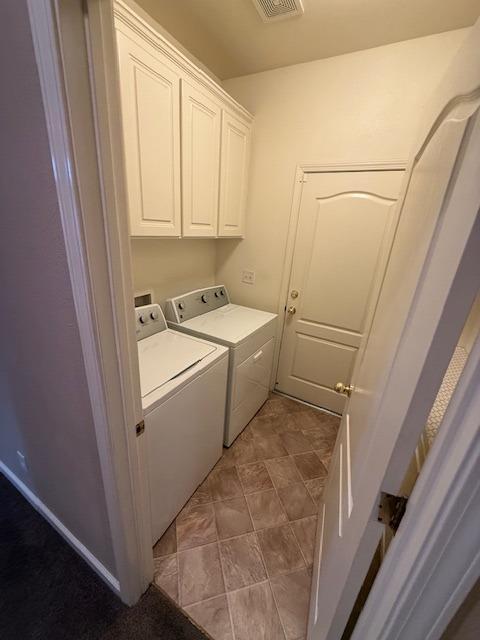 washroom with cabinets and separate washer and dryer