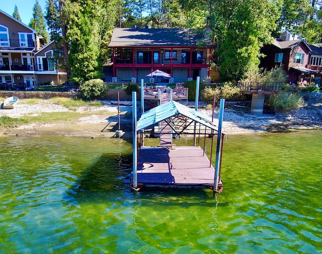 view of dock with a water view and a balcony