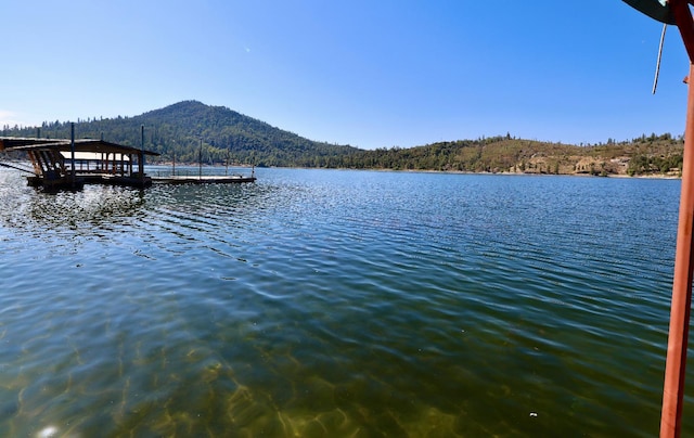 view of dock featuring a water and mountain view