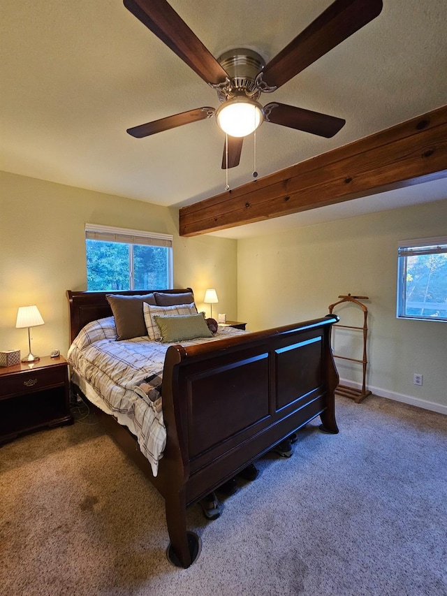 bedroom with ceiling fan, carpet floors, and multiple windows