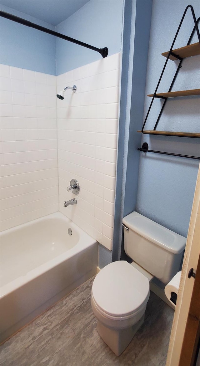 bathroom featuring toilet, tiled shower / bath combo, and hardwood / wood-style floors