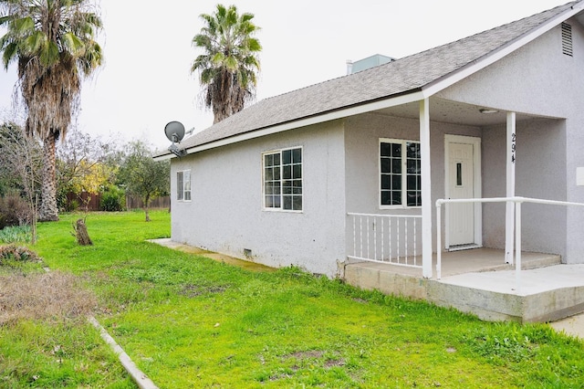 view of side of property with a yard