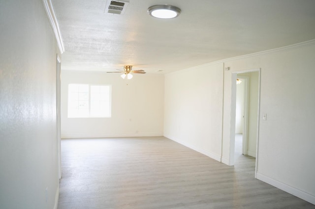 spare room with crown molding, a textured ceiling, ceiling fan, and light wood-type flooring