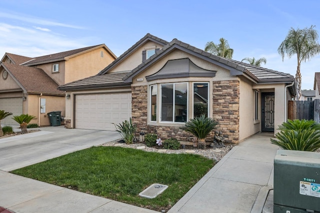 view of front of house with a garage and a front lawn