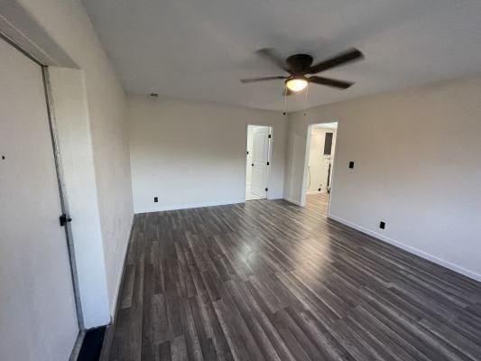 unfurnished room featuring dark hardwood / wood-style floors and ceiling fan