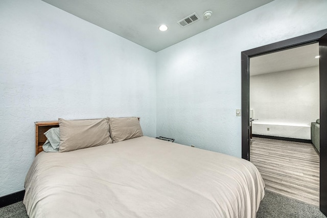 bedroom with hardwood / wood-style floors