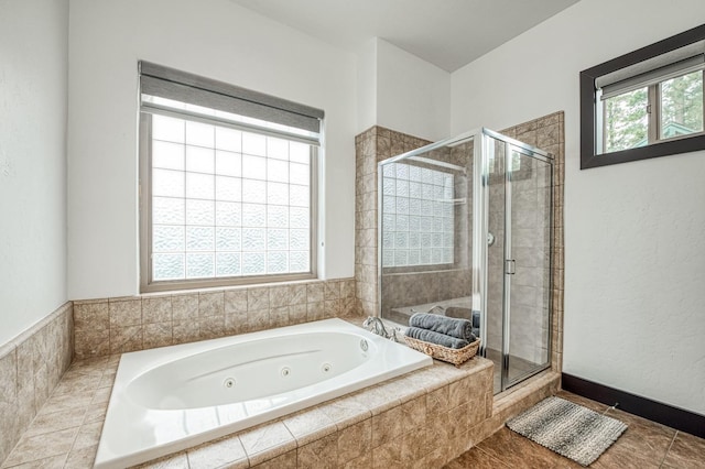 bathroom featuring shower with separate bathtub