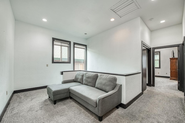 living room with light colored carpet and a healthy amount of sunlight