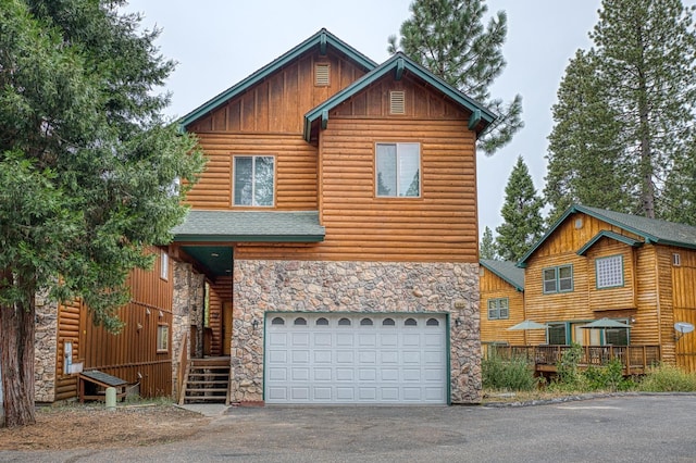 log home featuring a garage