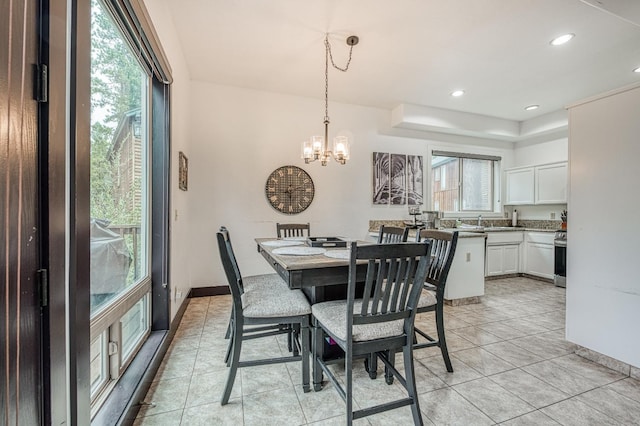 tiled dining space with an inviting chandelier and sink