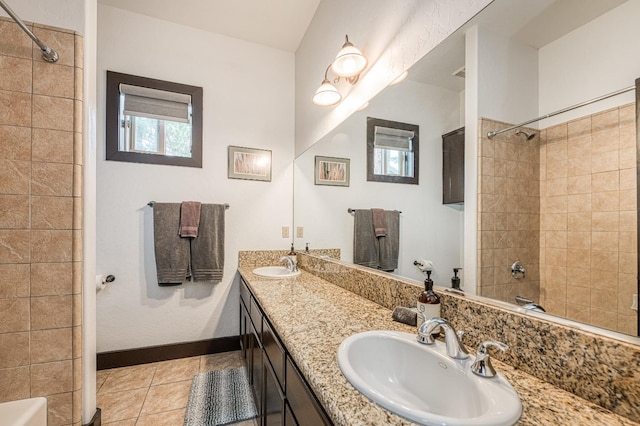 bathroom with tiled shower / bath, vanity, and tile patterned floors