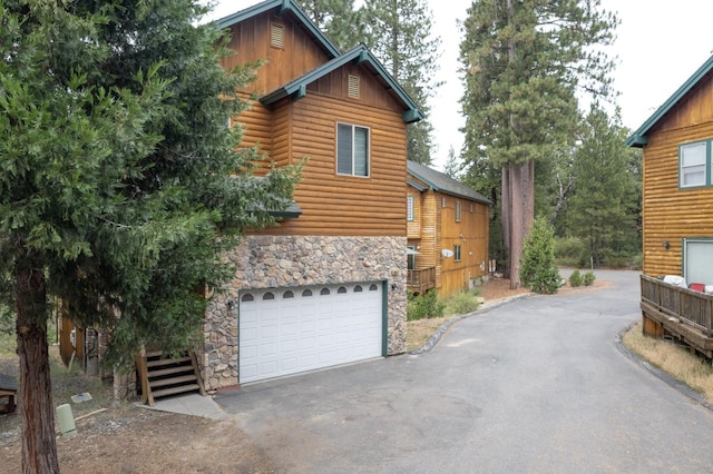 log-style house with a garage