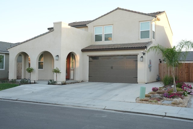 mediterranean / spanish home featuring a garage