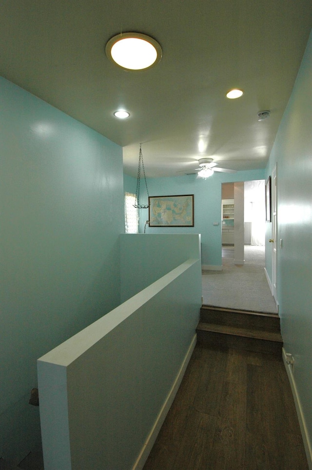 corridor with dark wood-type flooring and a wealth of natural light