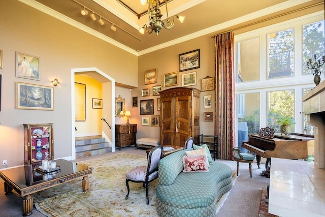 sitting room with a high ceiling, track lighting, crown molding, and carpet flooring