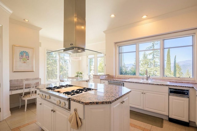 kitchen with a kitchen island, light stone countertops, stainless steel appliances, white cabinets, and island range hood