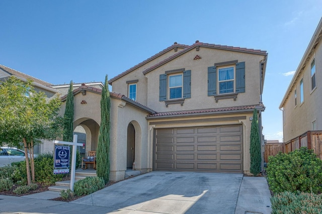 mediterranean / spanish-style house featuring a garage