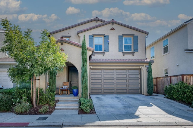 mediterranean / spanish home featuring a garage