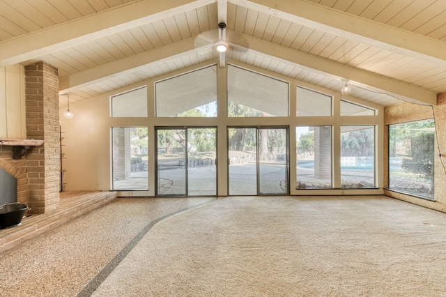 unfurnished living room with lofted ceiling with beams and carpet floors