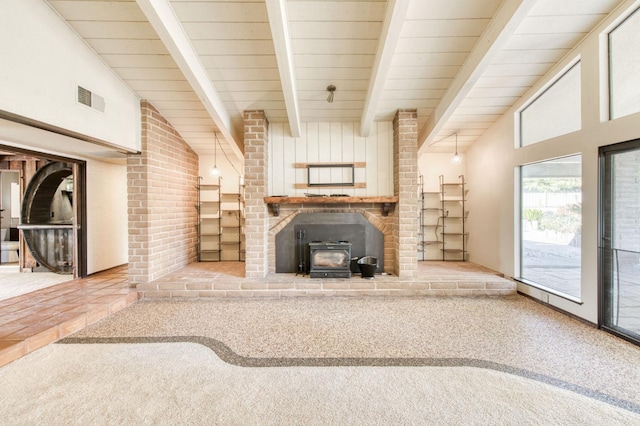 unfurnished living room featuring high vaulted ceiling, beam ceiling, carpet, and a wood stove