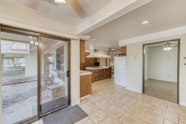 kitchen with white fridge, ceiling fan, and light colored carpet