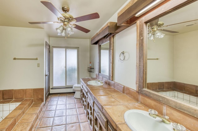 bathroom featuring ceiling fan, toilet, a bath, tile patterned floors, and vanity