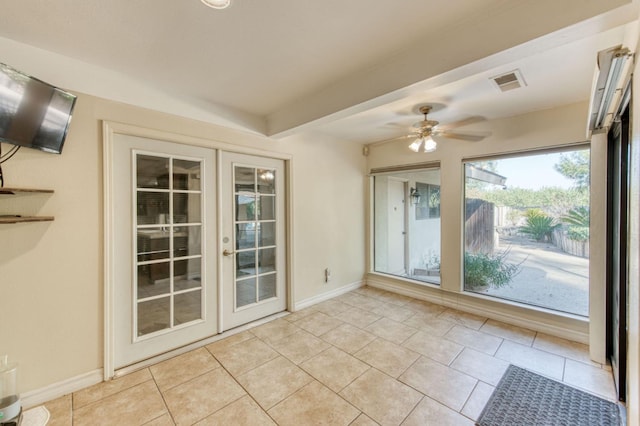 interior space with beamed ceiling, ceiling fan, and french doors