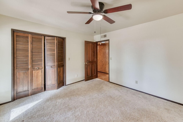 unfurnished bedroom with light carpet, ceiling fan, and a closet