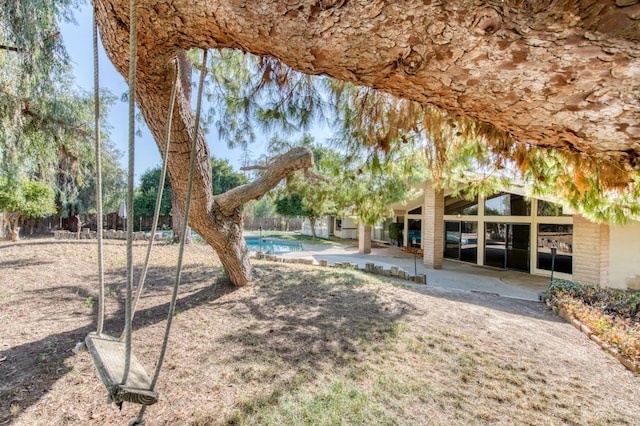 view of yard featuring a fenced in pool and a patio area