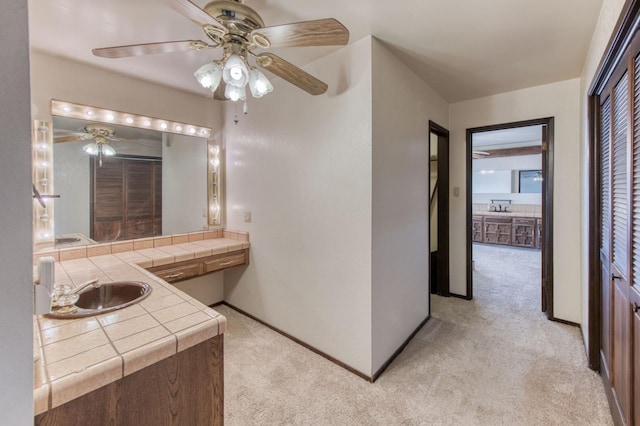 bathroom with ceiling fan and sink