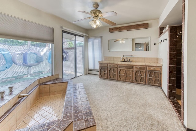 bathroom with ceiling fan, vanity, and baseboard heating