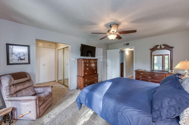 bedroom featuring ceiling fan and light carpet