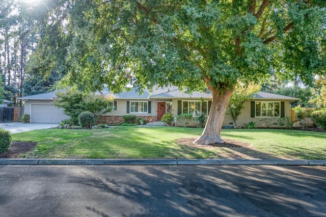 ranch-style house with a garage and a front yard