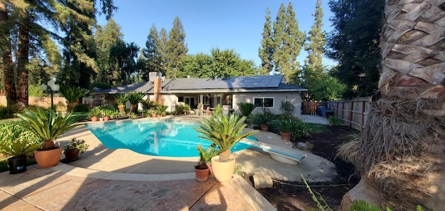 view of pool with a patio area and a diving board