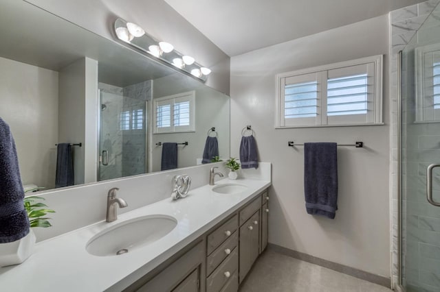 bathroom with tile patterned floors, vanity, and an enclosed shower