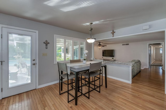 dining area with ceiling fan and light hardwood / wood-style flooring