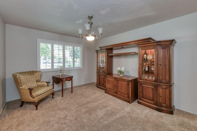 living area featuring a notable chandelier and light colored carpet