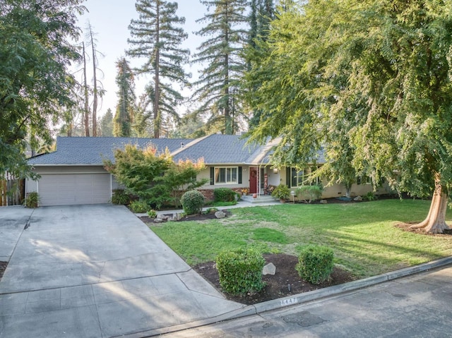 view of front of property with a garage and a front yard