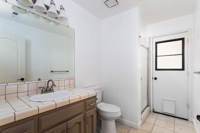 bathroom featuring an enclosed shower, toilet, tile patterned floors, vanity, and decorative backsplash