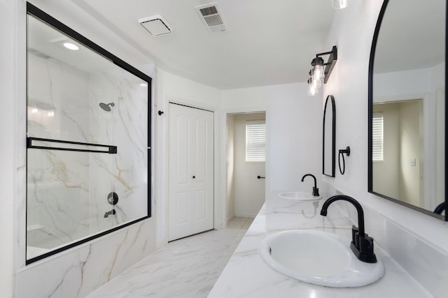 bathroom featuring vanity and tiled shower