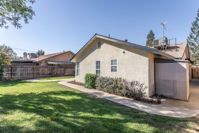 rear view of property featuring a patio and a lawn