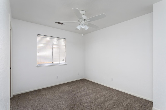 unfurnished room featuring ceiling fan and carpet