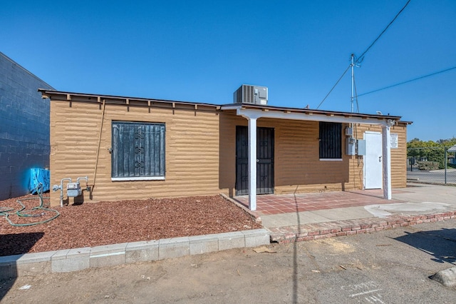 rear view of house featuring central AC unit and a patio