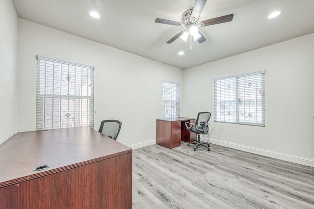 office space with light hardwood / wood-style floors and ceiling fan