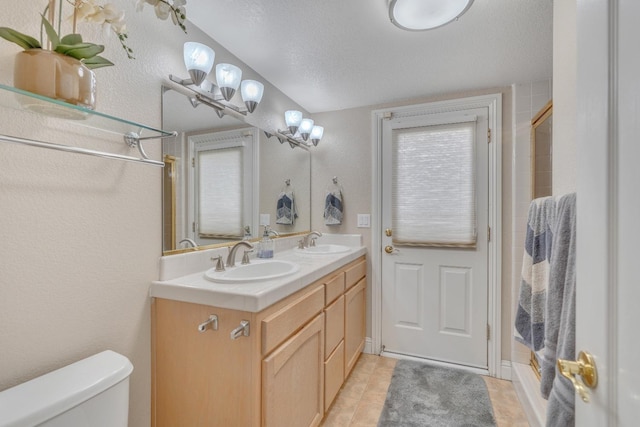 bathroom with walk in shower, a healthy amount of sunlight, toilet, vanity, and a textured ceiling