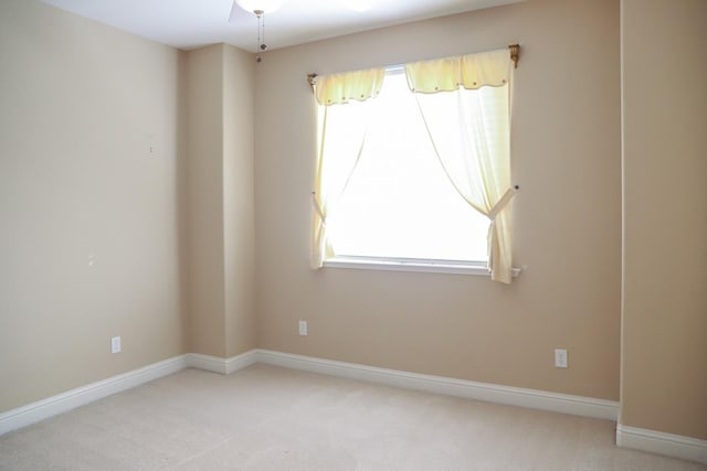 spare room featuring carpet flooring and ceiling fan