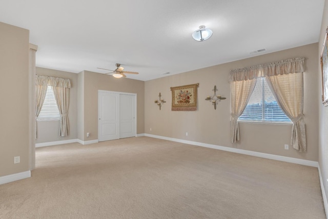 empty room with light carpet and ceiling fan