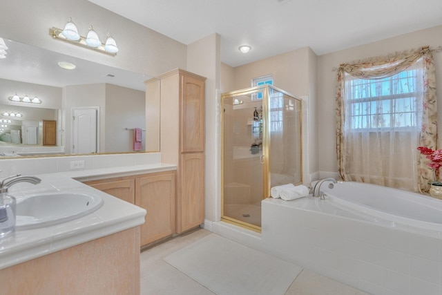 bathroom with tile patterned flooring, separate shower and tub, and vanity