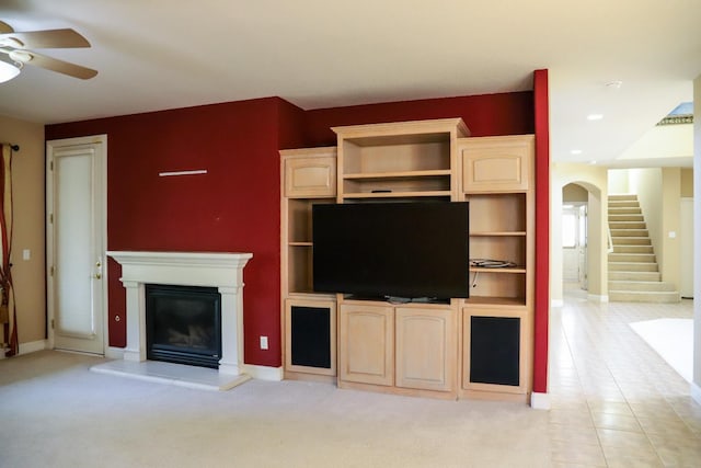 unfurnished living room with ceiling fan and light tile patterned floors