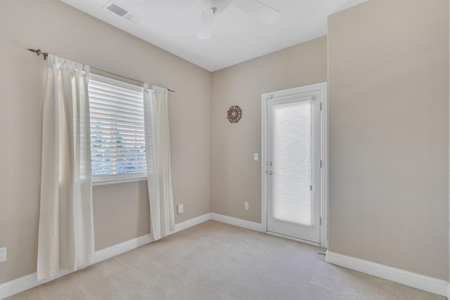 carpeted empty room featuring ceiling fan